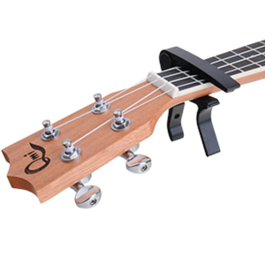 Picture showing a capo attached to a ukulele fretboard